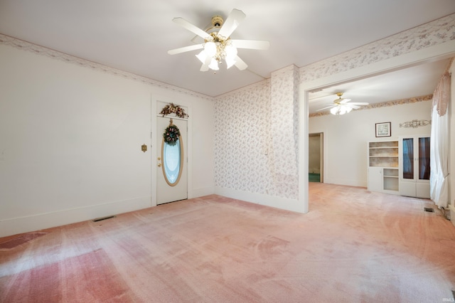 spare room with ceiling fan, wallpapered walls, light carpet, and baseboards