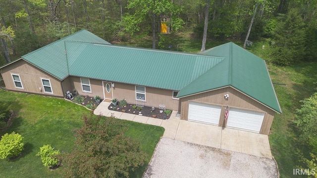 12067 E Bedrock Ln, Springville, IN 47462 - view of front of home with a front lawn, a garage, metal roof, and driveway