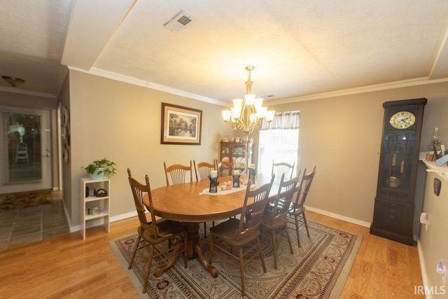 12067 E Bedrock Ln, Springville, IN 47462 - dining room with a chandelier, light wood-style floors, ornamental molding, and baseboards