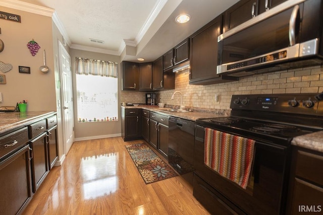 12067 E Bedrock Ln, Springville, IN 47462 - kitchen with black appliances, crown molding, a sink, tasteful backsplash, and dark brown cabinets
