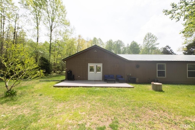 12067 E Bedrock Ln, Springville, IN 47462 - back of house featuring a patio, a yard, metal roof, and central air condition unit