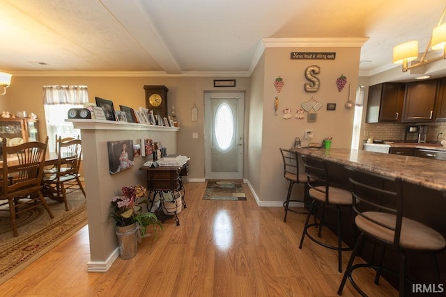12067 E Bedrock Ln, Springville, IN 47462 - entryway featuring light wood finished floors, ornamental molding, and baseboards