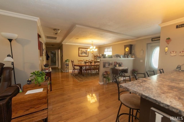 12067 E Bedrock Ln, Springville, IN 47462 - dining area with light wood finished floors, ornamental molding, a chandelier, and baseboards