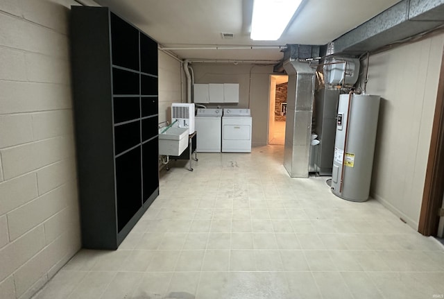 finished below grade area featuring water heater, washer and clothes dryer, heating unit, light flooring, and a sink