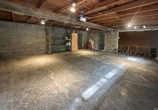 unfinished below grade area featuring concrete block wall