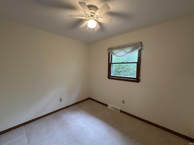 unfurnished room featuring light carpet, a ceiling fan, and baseboards