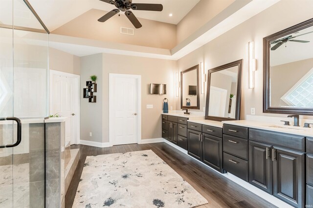 full bath featuring ceiling fan, double vanity, wood finished floors, baseboards, and recessed lighting