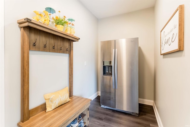 mudroom featuring dark wood-type flooring and baseboards