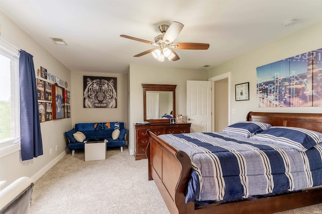 bedroom featuring light colored carpet, ceiling fan, and baseboards