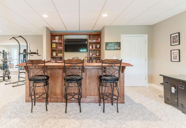 indoor bar with light carpet, recessed lighting, baseboards, and a drop ceiling