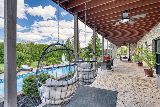 view of patio / terrace with a ceiling fan and an outdoor pool