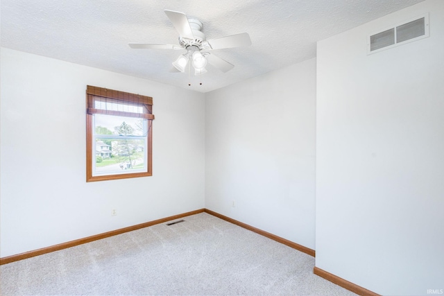 unfurnished room featuring carpet floors, baseboards, a ceiling fan, and a textured ceiling