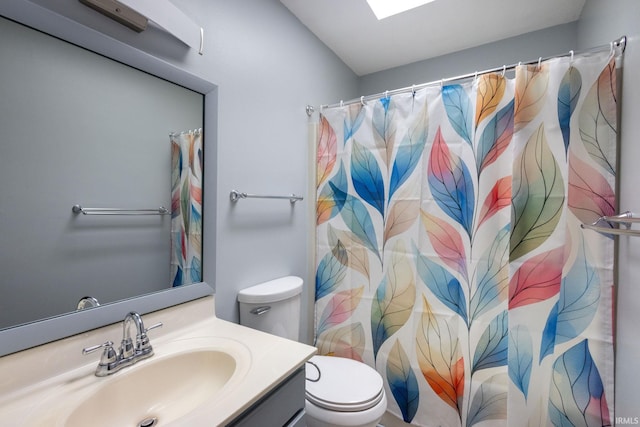bathroom with toilet, vanity, and a shower with shower curtain