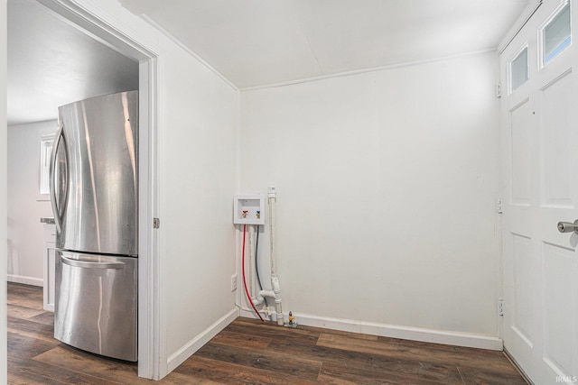 washroom featuring dark wood finished floors, baseboards, and hookup for a washing machine