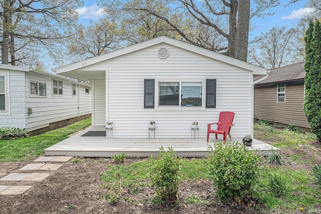 rear view of property featuring a wooden deck