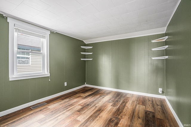 unfurnished room with wood finished floors and baseboards