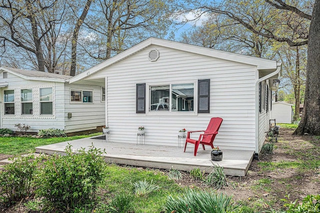rear view of house featuring a deck