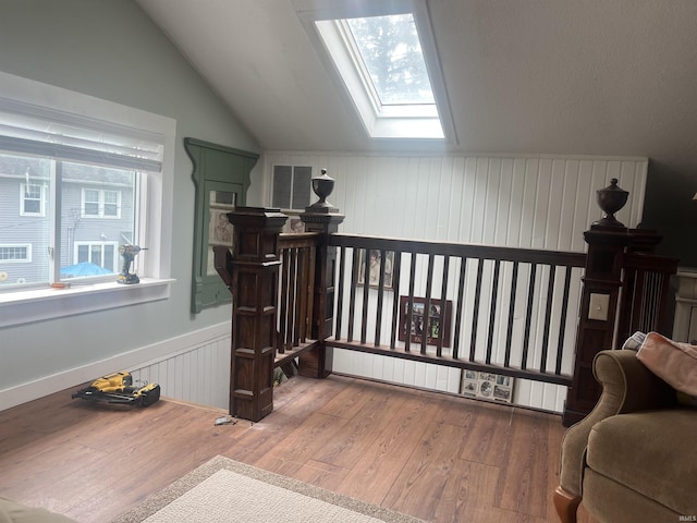 2515 Hubertus Ave, Fort Wayne, IN 46805 - sitting room featuring a skylight, lofted ceiling, wood finished floors, and wainscoting