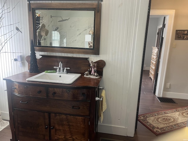 2515 Hubertus Ave, Fort Wayne, IN 46805 - bathroom with baseboards, vanity, a shower, and wood finished floors
