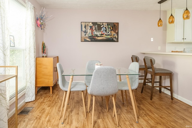 1005 E Buckingham Dr, Bloomington, IN 47401 - dining space with light wood-style flooring and baseboards