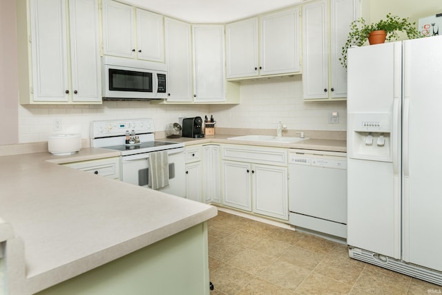 1005 E Buckingham Dr, Bloomington, IN 47401 - kitchen with white appliances, a sink, decorative backsplash, and light countertops