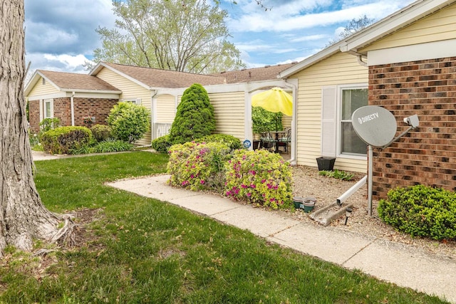 1005 E Buckingham Dr, Bloomington, IN 47401 - view of property exterior featuring a lawn and brick siding