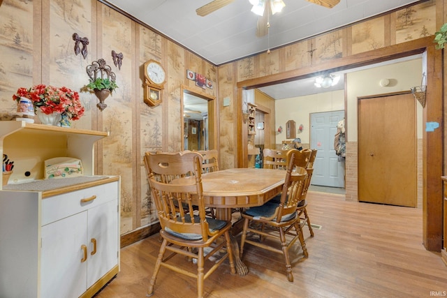 7950 E Metz Rd, Angola, IN 46703 - dining area featuring light wood-style floors, ceiling fan, and wood walls