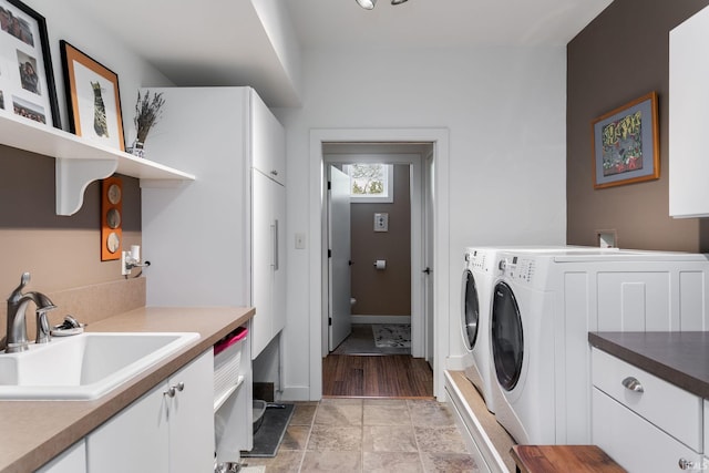 laundry room with washer and clothes dryer and cabinet space