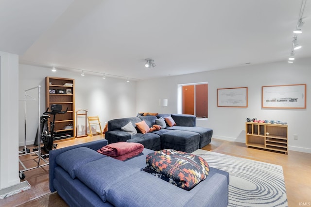 living area with track lighting and baseboards