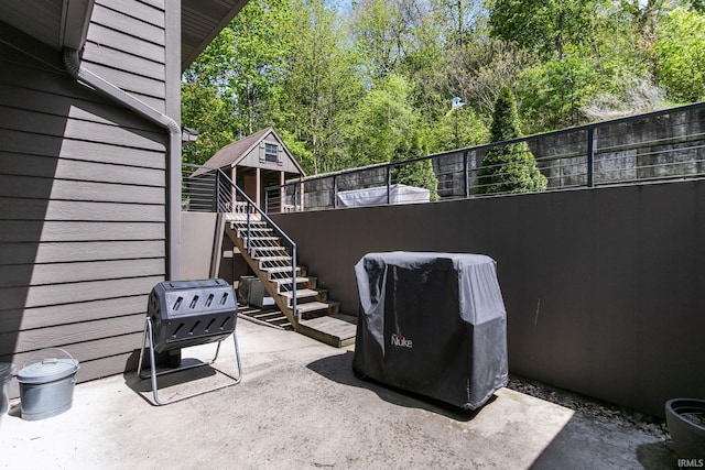 view of patio / terrace with stairs and fence