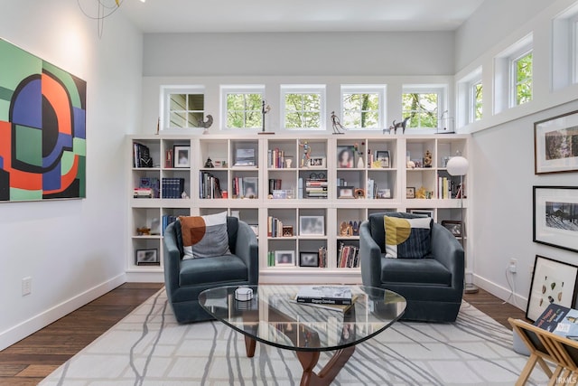 sitting room with baseboards and wood finished floors