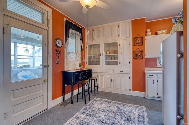 832 N Two Story Rd, Boonville, IN 47601 - kitchen with freestanding refrigerator, ceiling fan, carpet floors, white cabinets, and baseboards