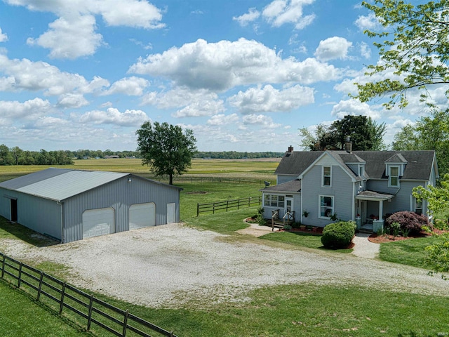 832 N Two Story Rd, Boonville, IN 47601 - view of side of property featuring a detached garage, an outdoor structure, a view of rural / pastoral area, a chimney, and metal roof