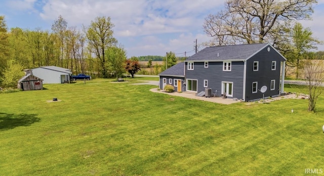 7325 E State Road 218, Lafontaine, IN 46940 - rear view of property with a yard, central air condition unit, a patio area, and an outdoor structure