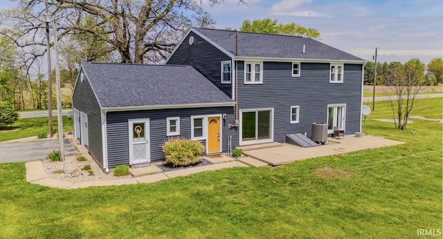 7325 E State Road 218, Lafontaine, IN 46940 - rear view of property with a lawn, a shingled roof, central AC unit, and a patio area
