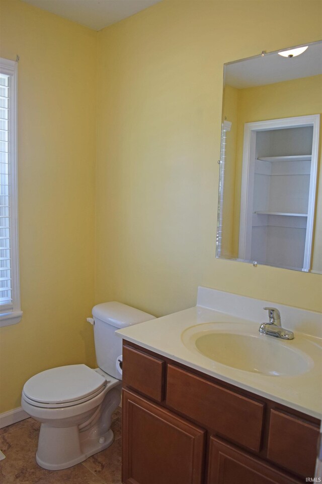 bathroom featuring toilet, vanity, and tile patterned floors