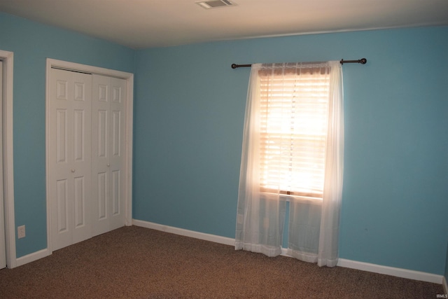 unfurnished bedroom featuring carpet floors and a closet