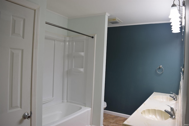 bathroom featuring crown molding, toilet, baseboards, shower / washtub combination, and double vanity