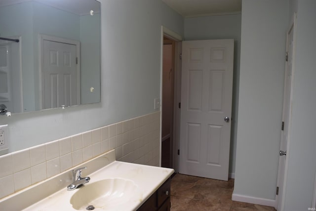 bathroom featuring vanity and tile walls