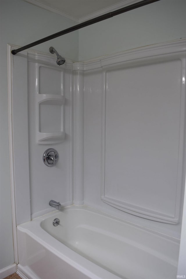 bathroom with  shower combination and crown molding