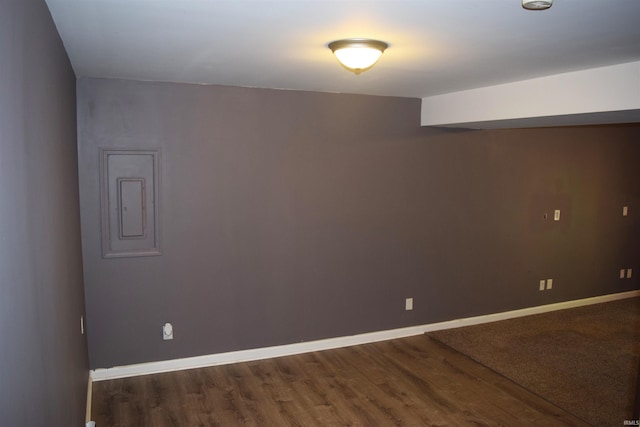 spare room with wood finished floors and baseboards