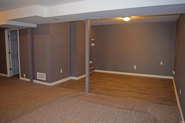 finished below grade area featuring baseboards and carpet floors