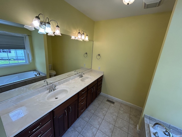 full bathroom featuring toilet, tile patterned floors, double vanity, a garden tub, and baseboards