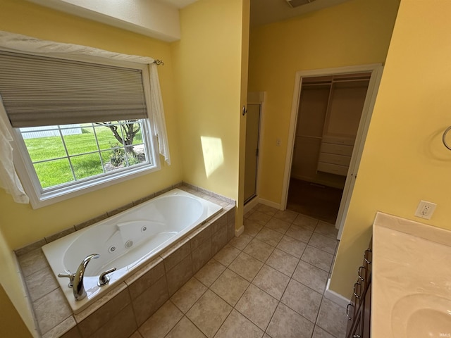 full bathroom with a shower stall, a tub with jets, tile patterned floors, vanity, and baseboards