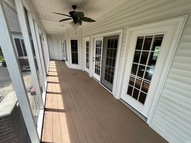 wooden deck featuring ceiling fan