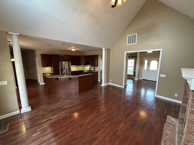 unfurnished living room with decorative columns, baseboards, high vaulted ceiling, and dark wood-type flooring