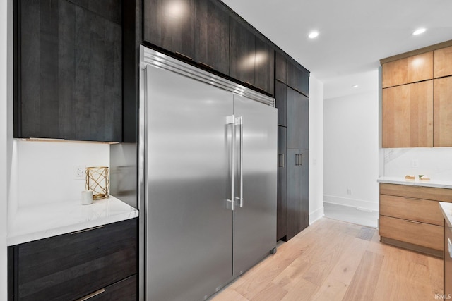15171 Gossamer Trl, Granger, IN 46530 - kitchen with built in fridge, light wood-type flooring, light countertops, baseboards, and modern cabinets