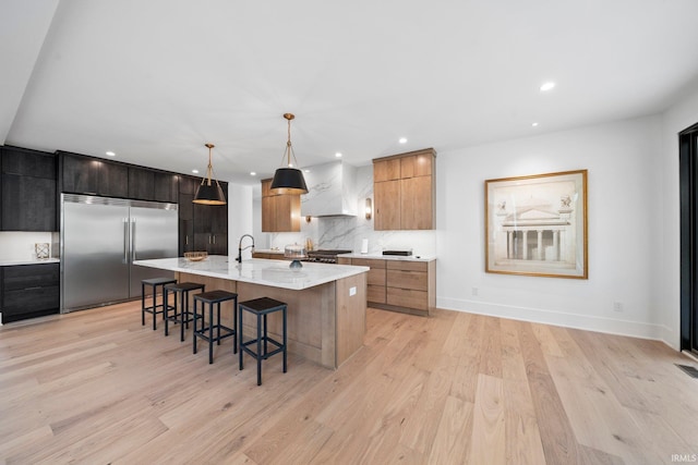 15171 Gossamer Trl, Granger, IN 46530 - kitchen with built in fridge, modern cabinets, a kitchen breakfast bar, light wood-style flooring, and recessed lighting