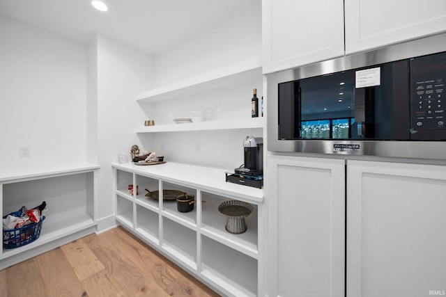 15171 Gossamer Trl, Granger, IN 46530 - kitchen view of stainless steel microwave, white cabinetry, open shelves, light wood-type flooring, and light countertops