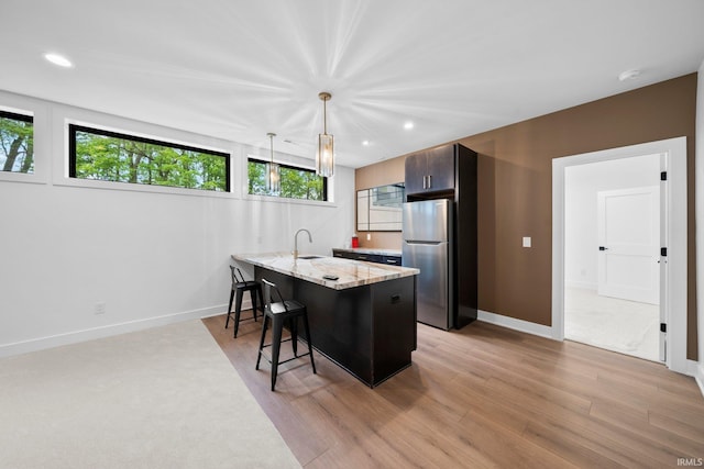 15171 Gossamer Trl, Granger, IN 46530 - kitchen with freestanding refrigerator, a kitchen breakfast bar, a sink, plenty of natural light, and recessed lighting